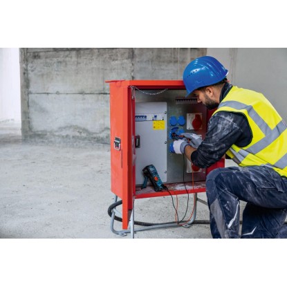 Elektrikář měří proud pomocí digitálního multimetru Bosch Professional GDM 600-15 na rozvodné skříni. Elektrikář měří proud pomocí digitálního multimetru Bosch Professional GDM 600-15 na rozvodné skříni.